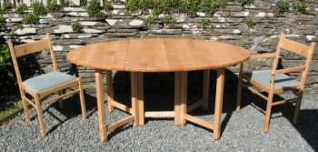 Gate leg table and chairs made from Sycamore. The gentle curves in the chairs are formed by "steam bending". A feature of the table is the unusual wooden hinge.